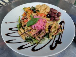 Salad : hummus, pasta, pickled onions, chickpeas, olives, rocket, pickled cucumber with chilli, etc. at Crippas Cafe in Gothenburg