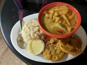Palmitos en Coco(Gluten Free & Soy Free) - Hearts of palms, onions and bell peppers in coconut milk, served with white rice & tostones. at Equelecua Cuban Cafe - Cloud Kitchen in Los Angeles