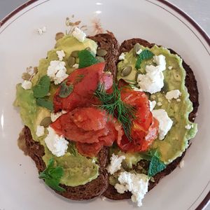 Dark rye, avo, roast tomato, almond feta, mint, dill, pepitas at Dear Daisy in Forestville