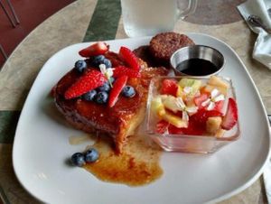 Salted Caramel Baked Challah French Toast with Organic Berries, Real Maple Syrup and Morningstar Vegetarian Sausage. at The Pearl Cafe in Chehalis