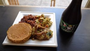A lunch: lentil burger, herb red rice, tofu in an herb / veggie sauce, seitan with creamy onions, and an organic red ale beer. at Mangia la Foglia Bio  in Parma