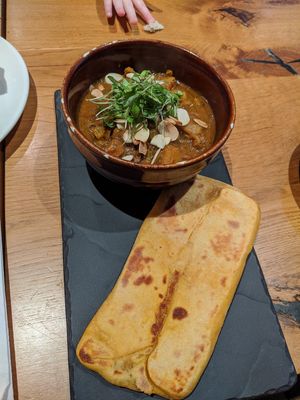 Peach and sweet potato tagine and naan, not very flavourful and claggy bland naan at Henderson's Vegan in Edinburgh