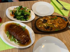 Mock duck, fried chicken and a broccoli dish  at Vege Saveurs in Paris