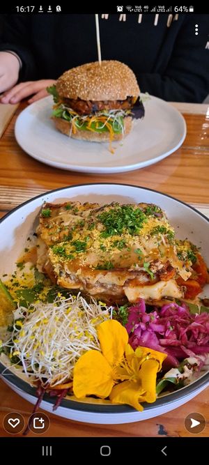 Lasagne & salad, jackfruit burger in background at Veggie Vie in Adelaide