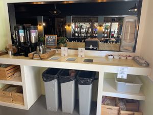 Coffee, condiment and trash area (no decaf)  at Thrive Juice Bar and Kitchen in Bar Harbor