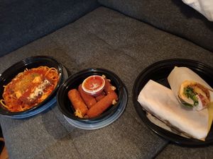 Left to right: mock chicken Parm over spaghetti, vegan mozzarella sticks, and fried zucchini hoagie! at Triangle Tavern in Philadelphia