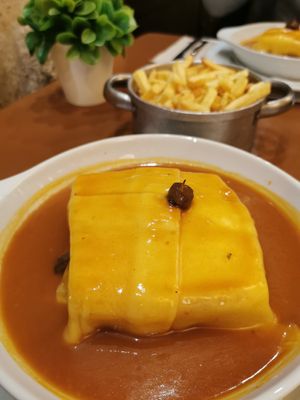 Francesinha with tofu and a side of chips at Francesinhas Al Forno da Baixa in Porto