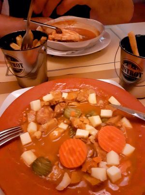 Half way through pica pau and francesinha at Francesinhas Al Forno da Baixa in Porto