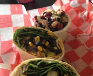 black bean & corn wrap with three bean salad side. at New Albanian Brewing Company Cafe and Brewhouse in New Albany
