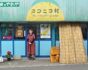 The owner, Michiko-san, posing in fron to the shop. Credit: beppueats.wordpress.com at Niconicomura Organic Vegan Food in Beppu