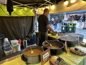Stall with dishes and examples of servings- kind attendants  at Ethiopiques - South Bank in South East London