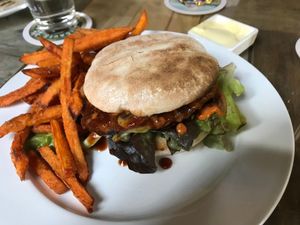Vegan mushroom burger with lentil-vegetable patty, sweet potato fries and vegan mayonnaise at Familienbetrieb in Mannheim