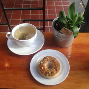 Seasonal pumpkin spiced vegan donut, and an earl grey tea at Cartems Donuts - Main St in Vancouver