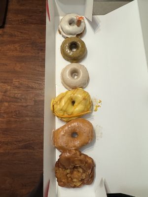 Half dozen with monthly specials baked carrot cake and mango passion fruit   at Cartems Donuts - Main St in Vancouver