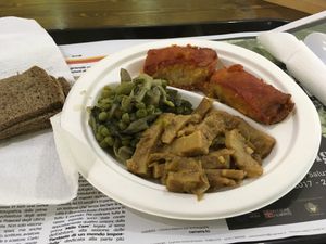 3 dishes plate served with bread for €5.30. Seitan, a pea salad, and eggplant and cous could parcels at Sapore Vegano in Turin