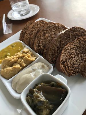 Couvert (pão preto com pastas de grão de bico, de inhame, caponata e de mostarda alcaparras) at Hotel Serra da Estrela - Restaurante Alquimia in Campos Do Jordao