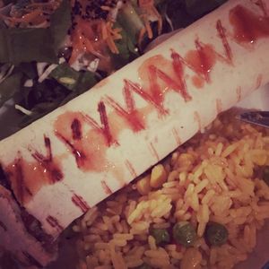 vegan burrito with sides of salad and rice. Stuffed with avocado and beans. at Appaloosa in Mykonos