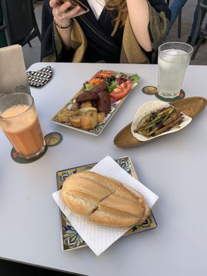 Vegan taco, vegan chorizo and bread roll with tomato at Recyclo Bike Cafe in Malaga