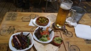 large beer and vegan taco at Recyclo Bike Cafe in Malaga