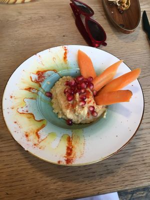 hummus with carrot sticks and pomegranate at Recyclo Bike Cafe in Malaga