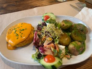 Tofu burger with salad and potatoes  at Vegetalia - Born in Barcelona