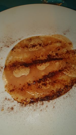 bollicine pere e liquirizia - Risotto with Prosecco, pear sauce, licorice cream, toasted almonds, and licorice powder at Cavoli Nostri in Naples