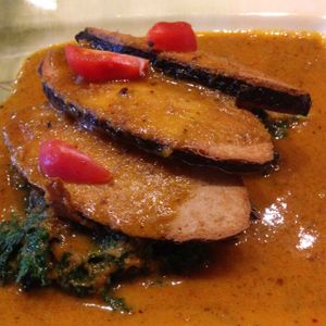 Pan seared soy fish w organic kale simmered w curry laksa at Herban Fix Vegan Kitchen in Atlanta