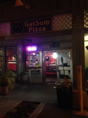 Store front at night at Get Sum Pizza in Kailua Kona