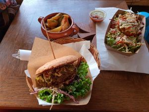Burger with fries and burger salad at Public Bar & Vegan Kitchen in Bled