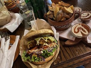 house burger and a side of potatoes  at Public Bar & Vegan Kitchen in Bled