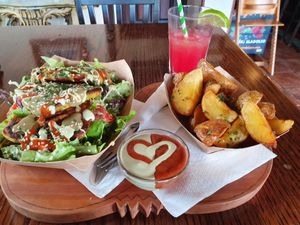 Chickpea fritters and salad + potato wedges, delicious sauce and watermelon juice at Public Bar & Vegan Kitchen in Bled