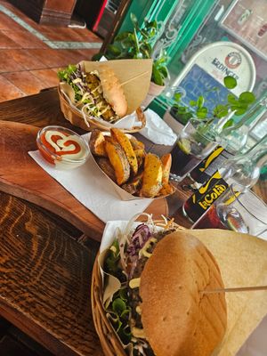 Club burger to the back, public burger in the front with wedges at Public Bar & Vegan Kitchen in Bled