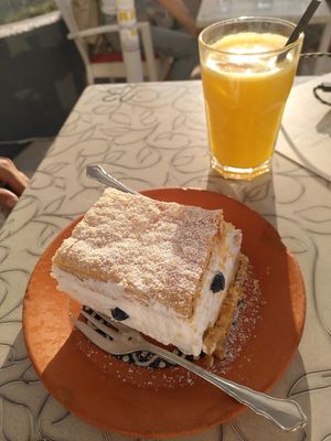 Bled cake and fresh orange juice at Public Bar & Vegan Kitchen in Bled