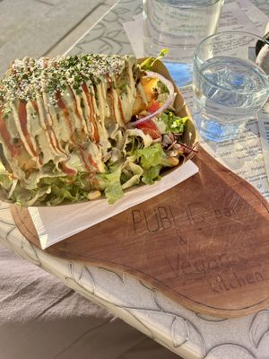 Outside seating with potato pie, enough for lunch the next day    at Public Bar & Vegan Kitchen in Bled