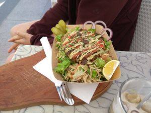 Bowl with a pattie and salad at Public Bar & Vegan Kitchen in Bled