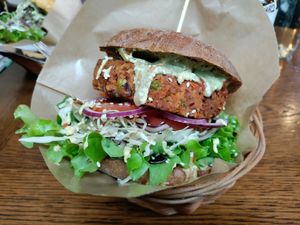 Bean burger patty in a buckwheat bun at Public Bar & Vegan Kitchen in Bled