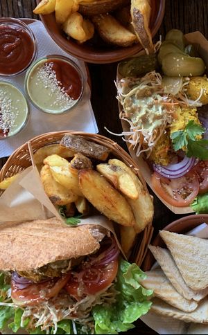 Club burger, hummus, roasted potatoes w/ sauces  at Public Bar & Vegan Kitchen in Bled