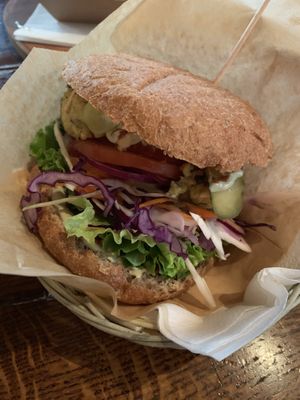 Summer burger on a spelt bun  at Public Bar & Vegan Kitchen in Bled