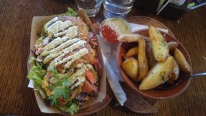 Zucchini fritters with salad and potato wedges. Yummy!!! at Public Bar & Vegan Kitchen in Bled