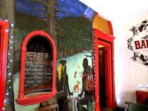 View of animal liberation mural and the Vegan Café's menu at The Barricade Inn Cafe in Dublin