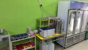 Silverware, drinking water, and ice in the cooler in the back.  at Jiya Chai in Phuket