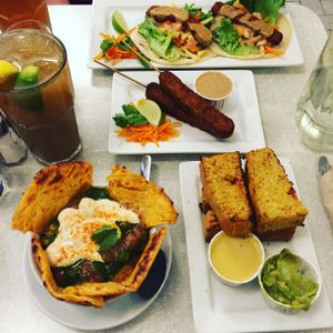All the goodness: tempeh tacos, tempeh skewers, chana paratha, and their epic cornbread. at Aux Vivres - Comptoir Pret a Manger in Montreal