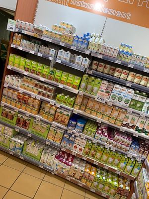 Wall of non dairy milks  at L'Eau Vive in Courbevoie