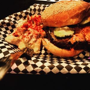 Peanut butter and tempeh bacon burger with potatoe salad, b&b pickles at Black Water Bar in Portland