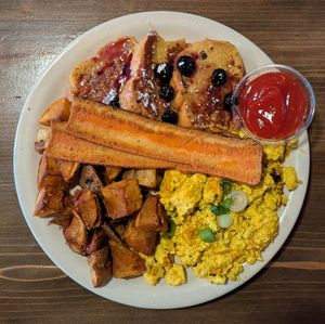 French toast with blueberry syrup, cheesy tofu scramble, Cajun home fries, and Thrilling Foods bakon at Black Water Bar in Portland