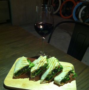 a glass of red wine, and a Mexican seitan wrap at Happy Buddha - Pop-Up in Shanghai