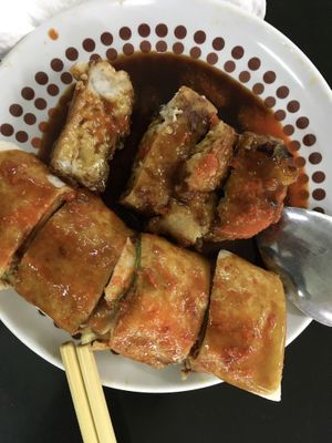 Vegan fried radish cake and popiah drenched in chilli and sweet soy sauce  at Blue Boy Vegetarian Food Centre in Kuala Lumpur