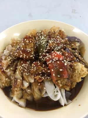 Chee cheong fun (flat rice noodles with sesame hoisin sauce, fried tofu skin, stuffed chilli and eggplant) at Blue Boy Vegetarian Food Centre in Kuala Lumpur