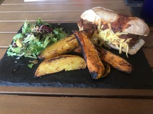Vegan “meatball” sub. Homemade wedges and side salad. Amazing!  at The Green HeART Cafe  in Newquay