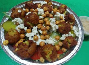 Vegan Falafel Salad: Homemade vegan‏ falafel, hummus, veggies, vegan feta, crunchy beans, and hummus. Topped with a red wine vinaigrette.  at Pizza & Sub Stop in Lowell